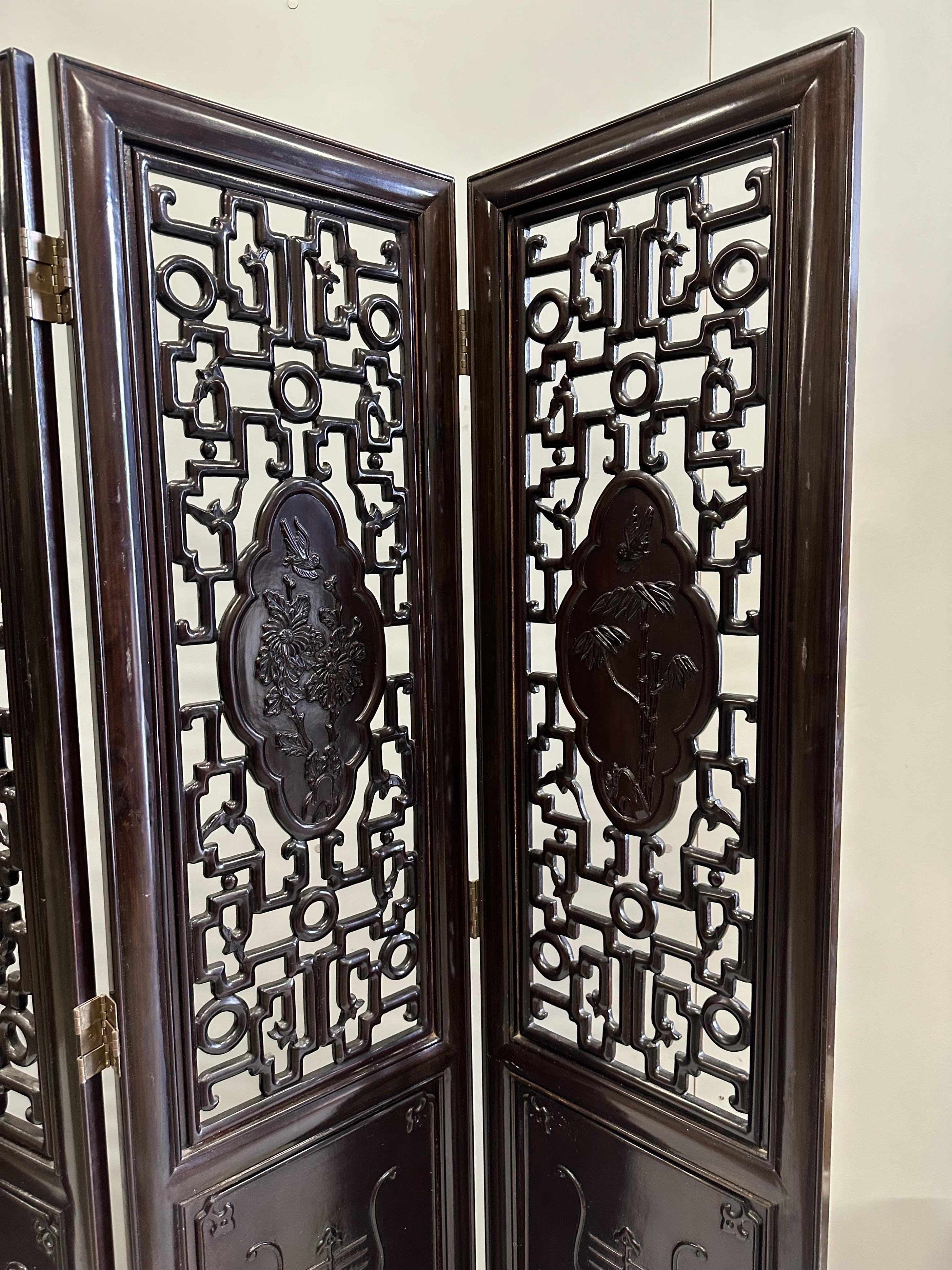 A Chinese carved hardwood four fold screen, each panel width 45cm, height 183cm. Condition - good